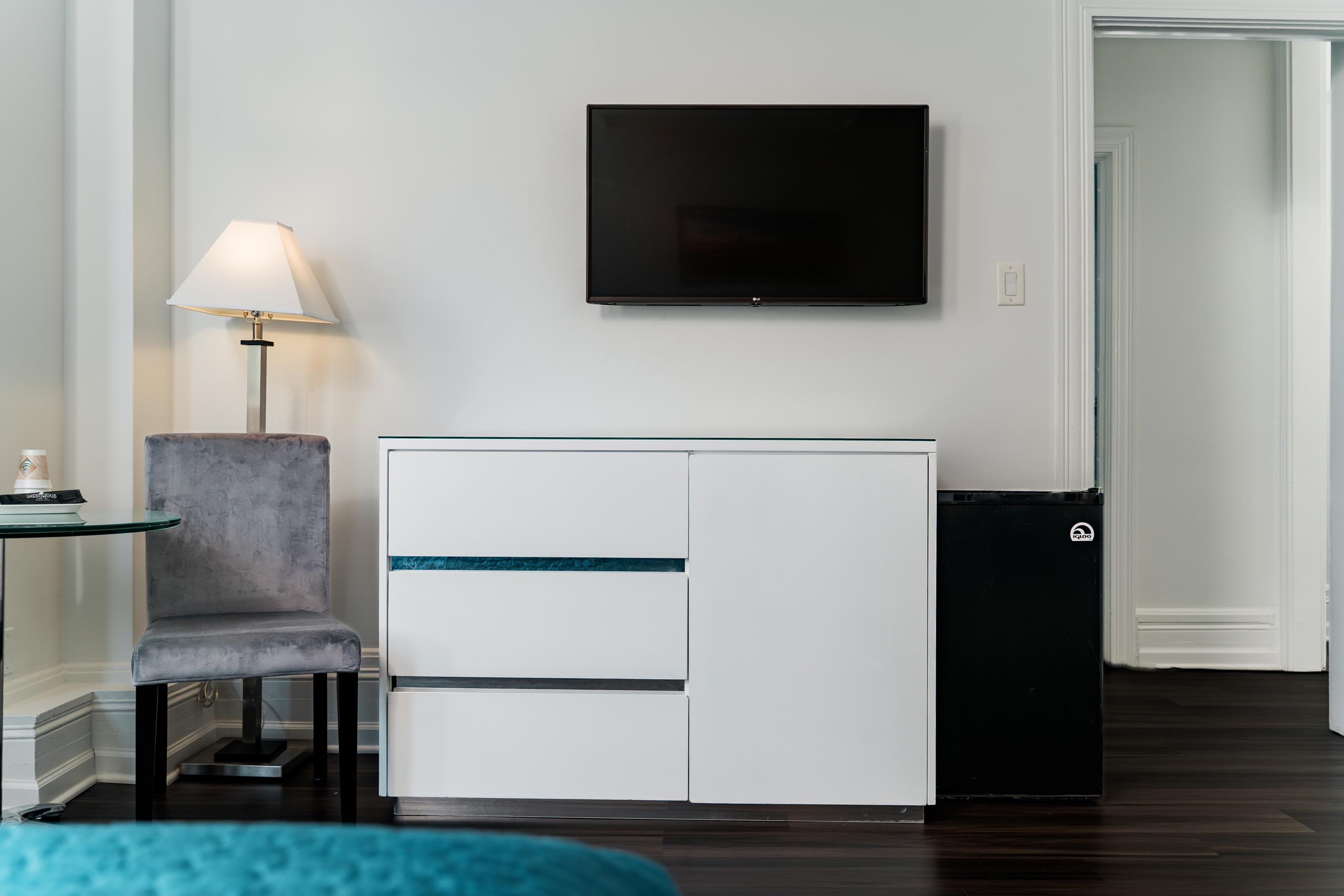 TV mounted on a wall and a storage cabinet