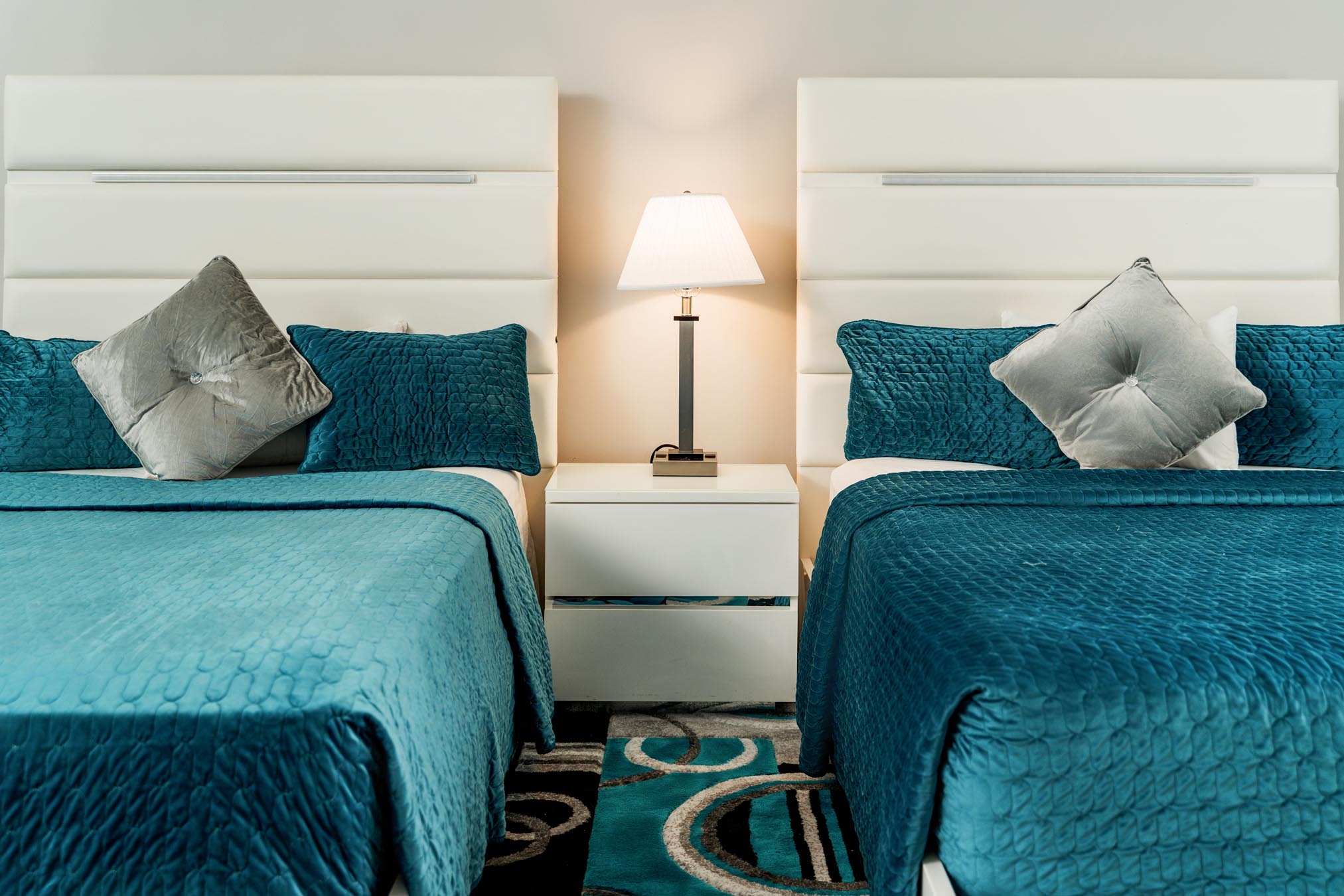two beds with blue comforters